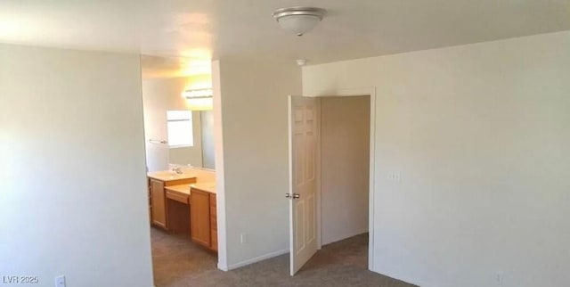 3883 Winter Whitetail St, Las Vegas, NV 89122 - unfurnished bedroom with a sink, connected bathroom, and light colored carpet