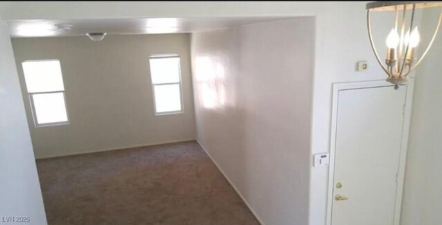 3883 Winter Whitetail St, Las Vegas, NV 89122 - carpeted spare room with baseboards, a healthy amount of sunlight, and a chandelier