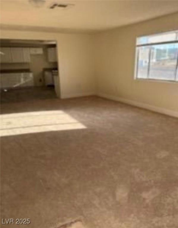 664 Sky Rd, Indian Springs, NV 89018 - carpeted spare room with baseboards