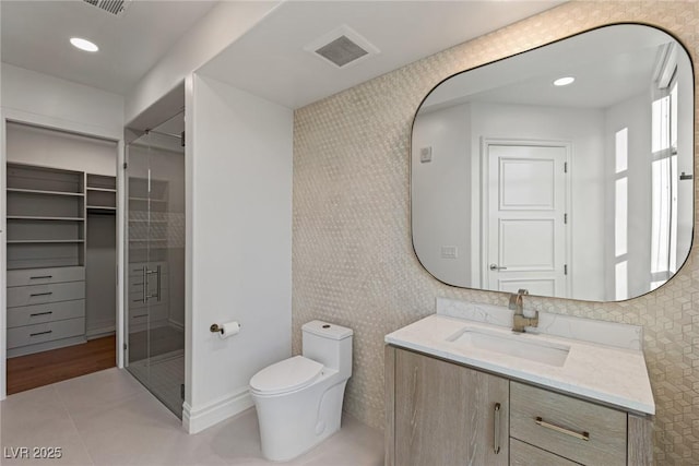 full bath with a stall shower, toilet, visible vents, tile patterned flooring, and vanity