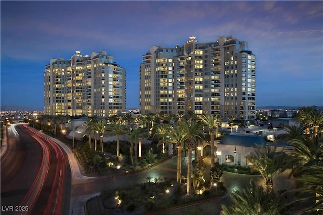 property at dusk featuring a city view