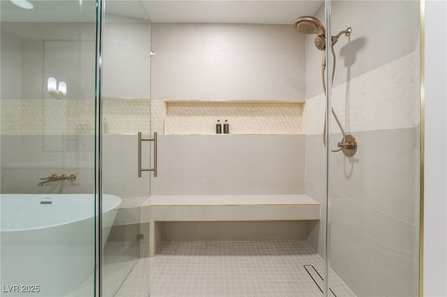 bathroom featuring a soaking tub, tile patterned floors, and a stall shower