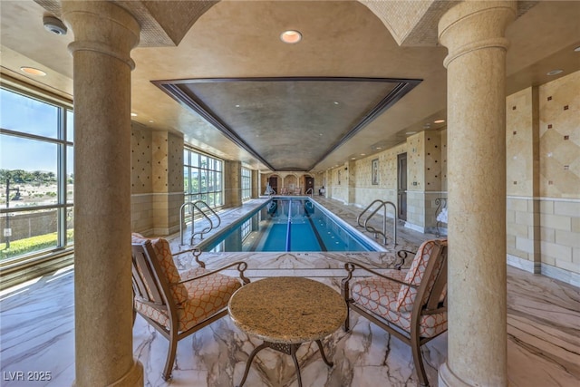 view of pool with ornate columns