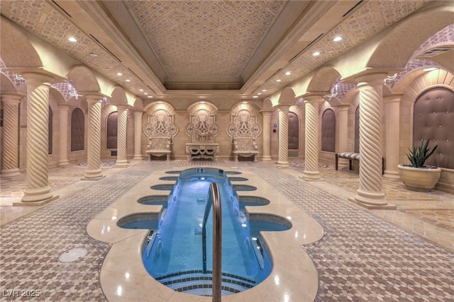 view of pool featuring a hot tub and ornate columns