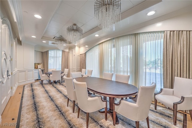 dining room featuring a tray ceiling, recessed lighting, a chandelier, and ornamental molding