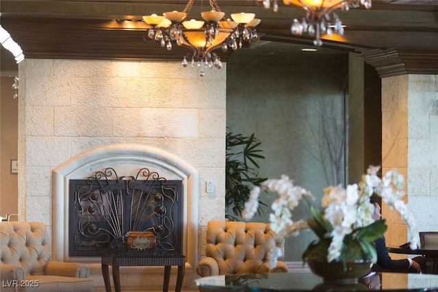 interior details featuring a fireplace and an inviting chandelier