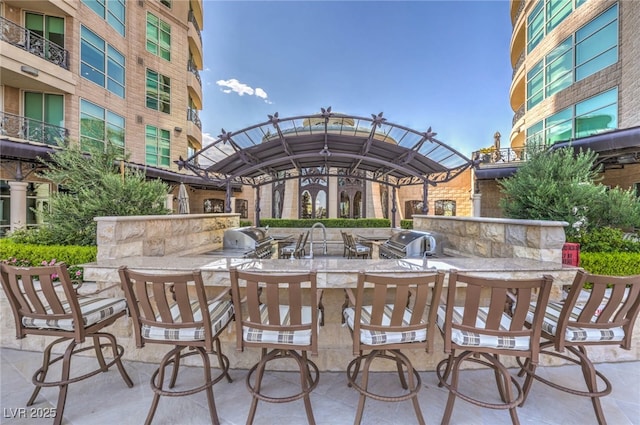view of patio with area for grilling and exterior kitchen