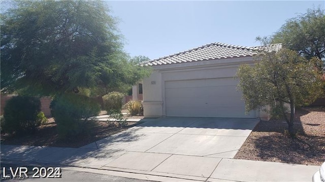 garage with concrete driveway
