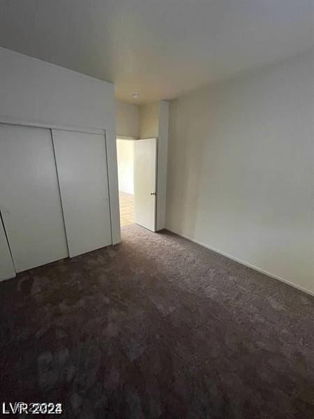 unfurnished bedroom featuring a closet and carpet