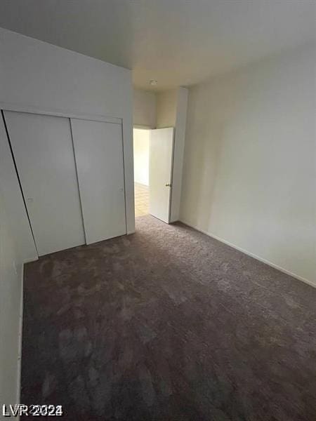 unfurnished bedroom featuring a closet and carpet floors