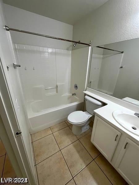 bathroom featuring toilet, tile patterned flooring, vanity, and bathing tub / shower combination