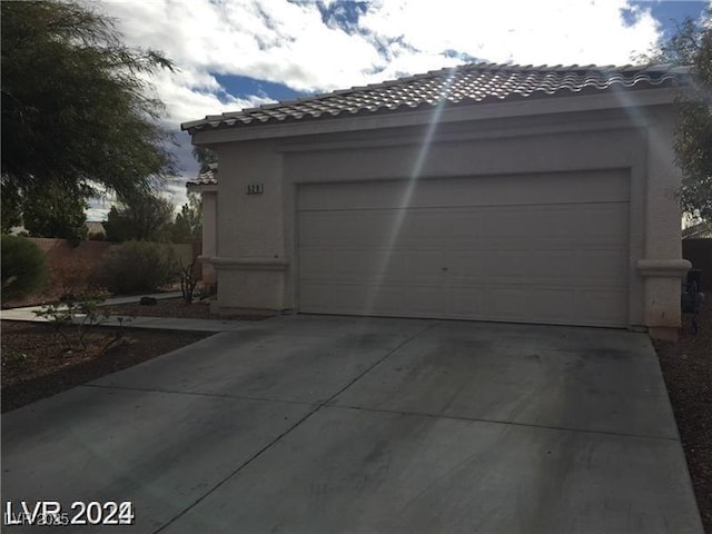 garage with concrete driveway