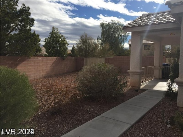 view of yard with fence and central AC