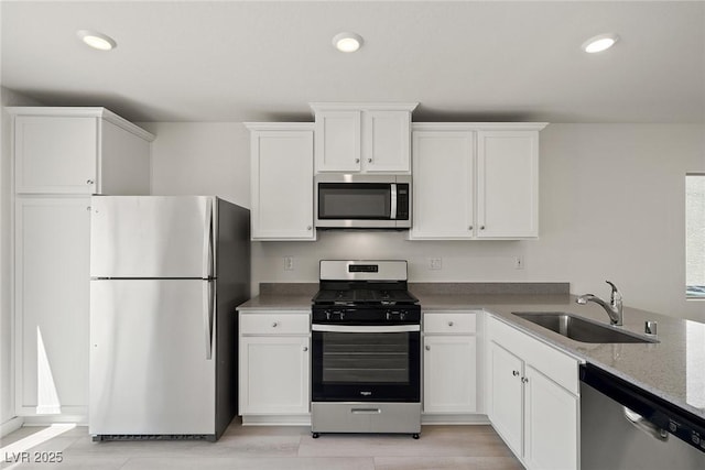2618 Lily Point St, Las Vegas, NV 89156 - kitchen featuring stainless steel appliances, a sink, white cabinets, recessed lighting, and light stone countertops