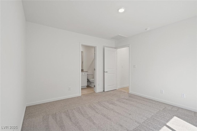 2618 Lily Point St, Las Vegas, NV 89156 - unfurnished bedroom with light carpet, baseboards, ensuite bath, and recessed lighting