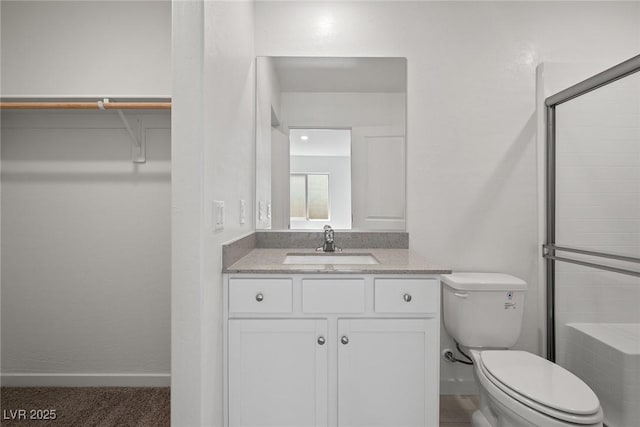 2618 Lily Point St, Las Vegas, NV 89156 - full bathroom with toilet, vanity, a shower with door, baseboards, and a walk in closet