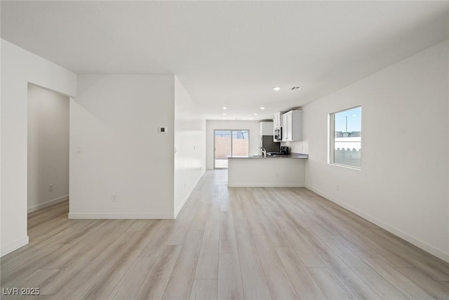 2618 Lily Point St, Las Vegas, NV 89156 - unfurnished living room with light wood-type flooring, baseboards, and recessed lighting