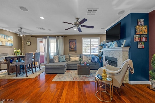 8600 W Charleston Blvd Unit 2078, Las Vegas, NV 89117 - living room with ceiling fan, wood finished floors, crown molding, a fireplace, and baseboards