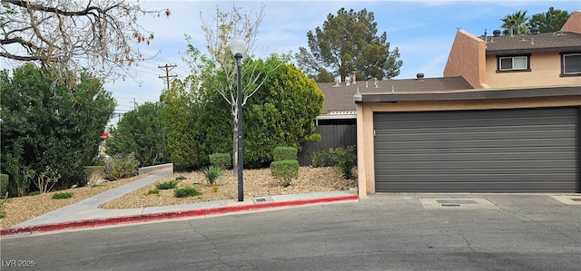 exterior space featuring fence and stucco siding