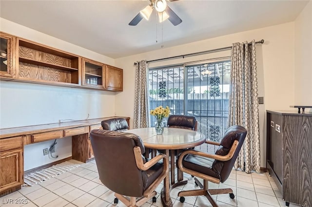 dining space featuring ceiling fan, built in study area, and light tile patterned floors