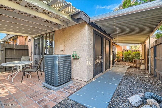 view of patio / terrace with cooling unit and fence