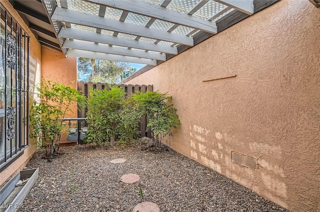 view of yard featuring a pergola and fence