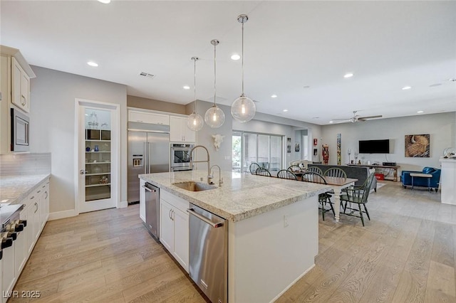 10840 Rosin Jaw St, Las Vegas, NV 89183 - kitchen featuring light wood-style flooring, a ceiling fan, visible vents, a sink, and built in appliances