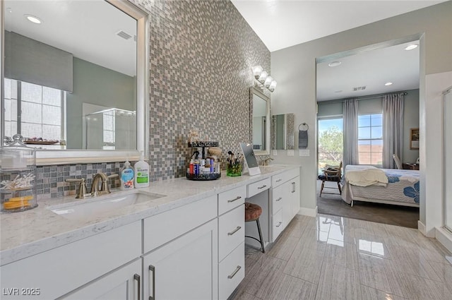 10840 Rosin Jaw St, Las Vegas, NV 89183 - full bathroom featuring visible vents, a sink, ensuite bath, decorative backsplash, and a stall shower