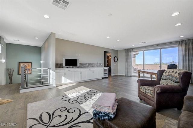 10840 Rosin Jaw St, Las Vegas, NV 89183 - living area with visible vents, recessed lighting, beverage cooler, and wood finished floors