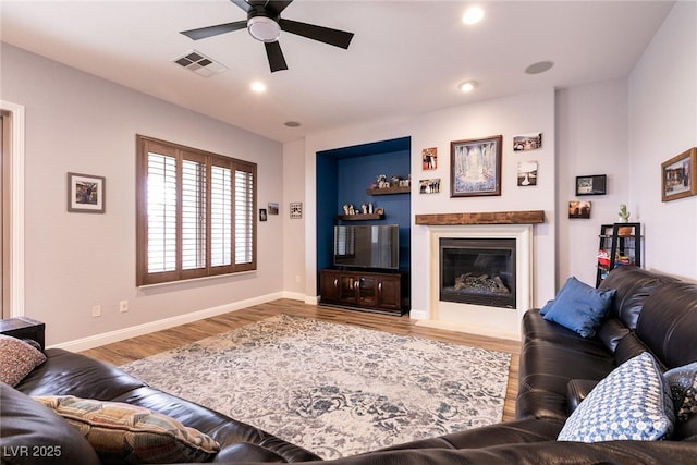 7416 Redhead Dr, North Las Vegas, NV 89084 - living room with ceiling fan, a glass covered fireplace, wood finished floors, baseboards, and recessed lighting