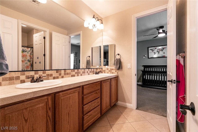7416 Redhead Dr, North Las Vegas, NV 89084 - bathroom with double vanity, tasteful backsplash, tile patterned flooring, ceiling fan, and baseboards
