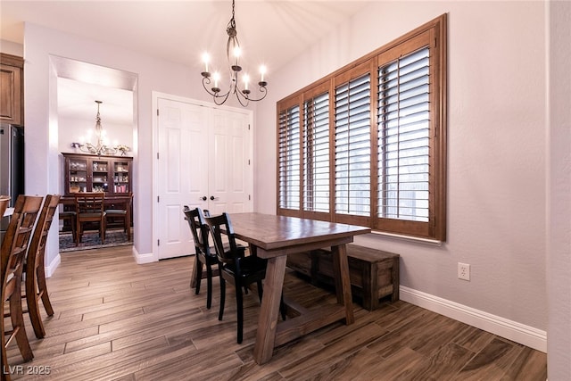 7416 Redhead Dr, North Las Vegas, NV 89084 - dining area featuring a chandelier, wood finished floors, and baseboards