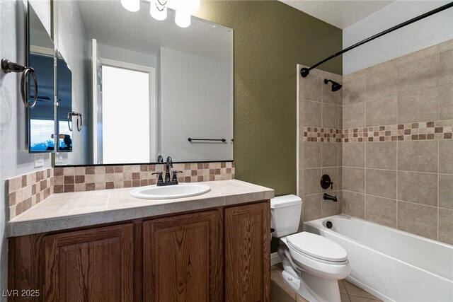 7416 Redhead Dr, North Las Vegas, NV 89084 - bathroom with vanity, washtub / shower combination, backsplash, a textured wall, and tile patterned flooring