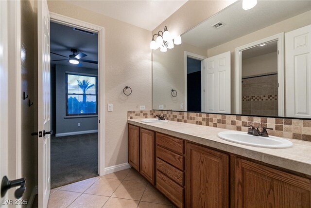 7416 Redhead Dr, North Las Vegas, NV 89084 - bathroom featuring double vanity, decorative backsplash, tile patterned flooring, and a ceiling fan