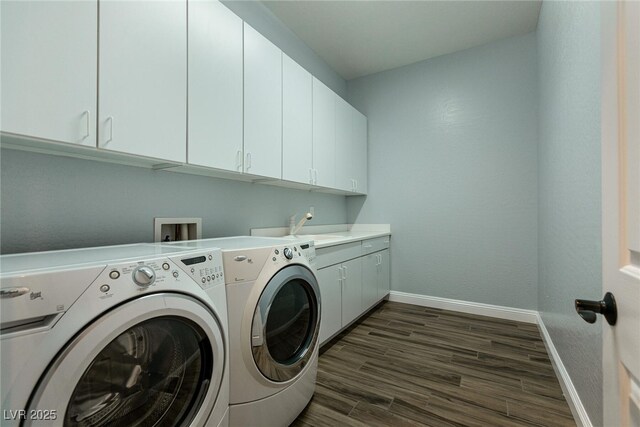 7416 Redhead Dr, North Las Vegas, NV 89084 - washroom featuring washing machine and clothes dryer, cabinet space, and dark wood-style floors