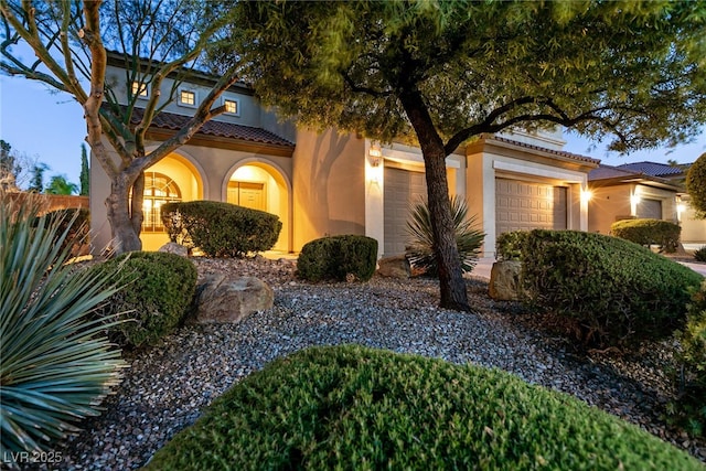 7416 Redhead Dr, North Las Vegas, NV 89084 - mediterranean / spanish-style home featuring a garage, stucco siding, and a tiled roof