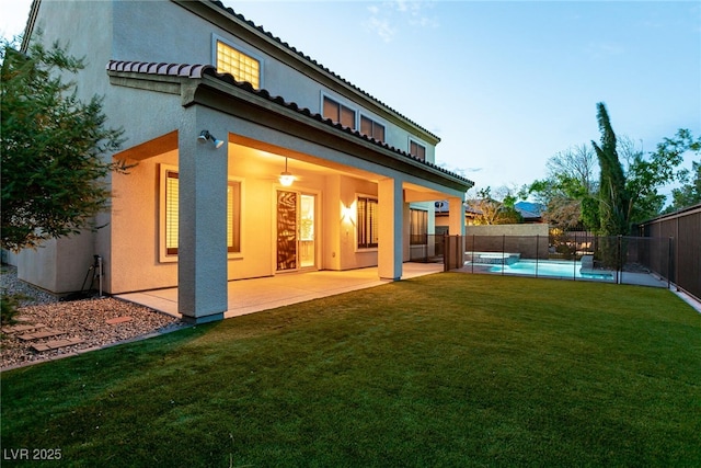7416 Redhead Dr, North Las Vegas, NV 89084 - rear view of property featuring stucco siding, a fenced backyard, a patio area, and a tile roof