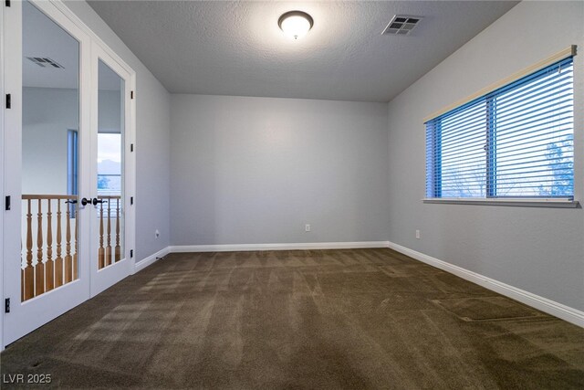 7416 Redhead Dr, North Las Vegas, NV 89084 - empty room with carpet flooring, a textured ceiling, and french doors