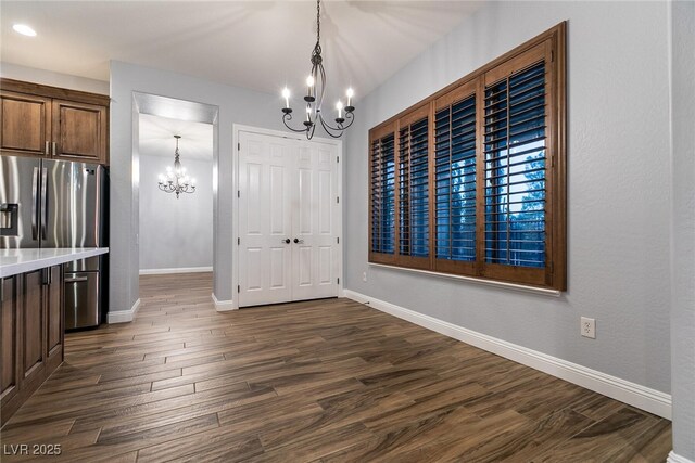 7416 Redhead Dr, North Las Vegas, NV 89084 - unfurnished dining area with a chandelier, dark wood-style floors, and recessed lighting