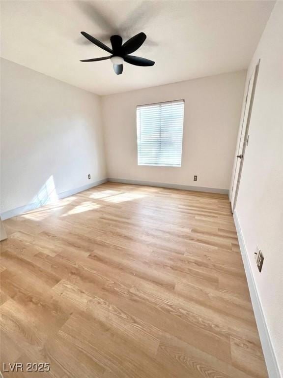 unfurnished room featuring baseboards and light wood-type flooring