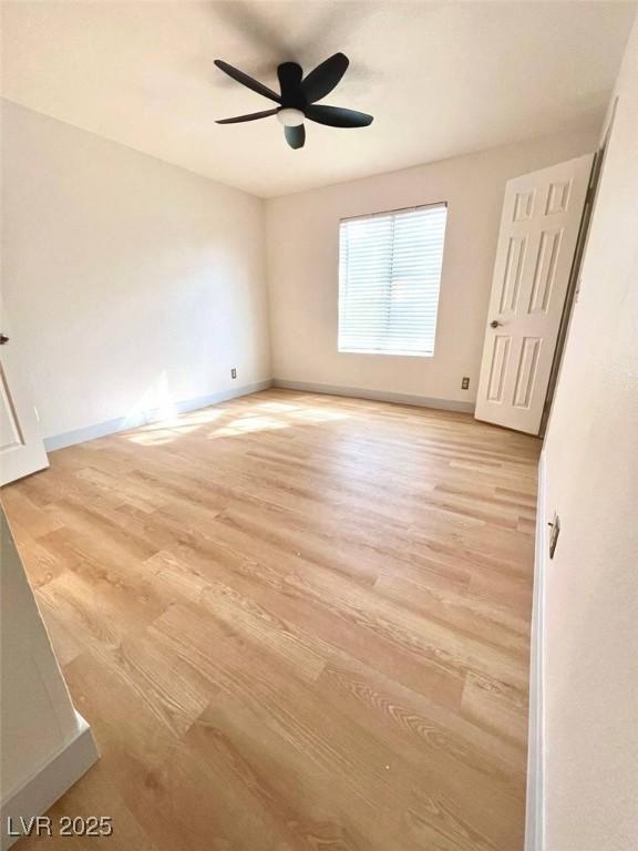 unfurnished bedroom with a ceiling fan, baseboards, and light wood finished floors