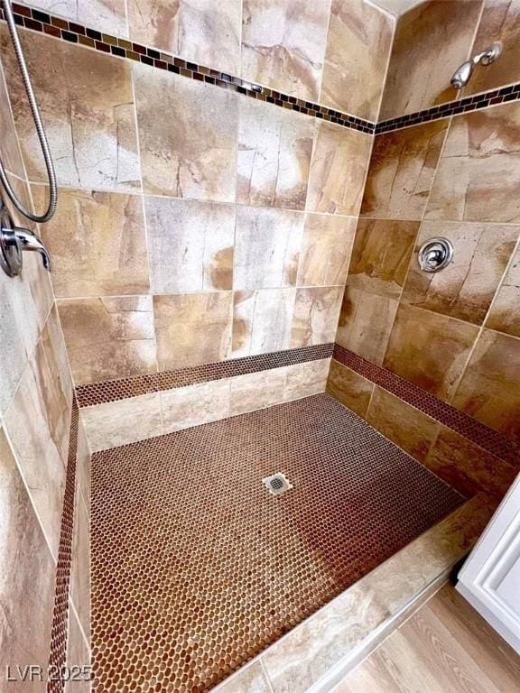 bathroom with a tile shower