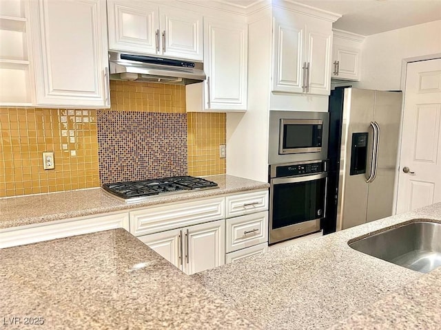 kitchen featuring white cabinets, stainless steel appliances, and under cabinet range hood