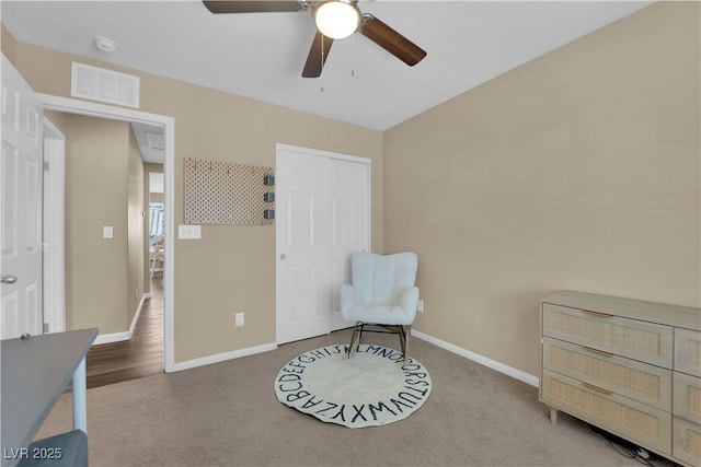 sitting room with carpet, baseboards, ceiling fan, and visible vents
