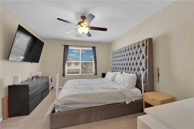 carpeted bedroom featuring visible vents and a ceiling fan