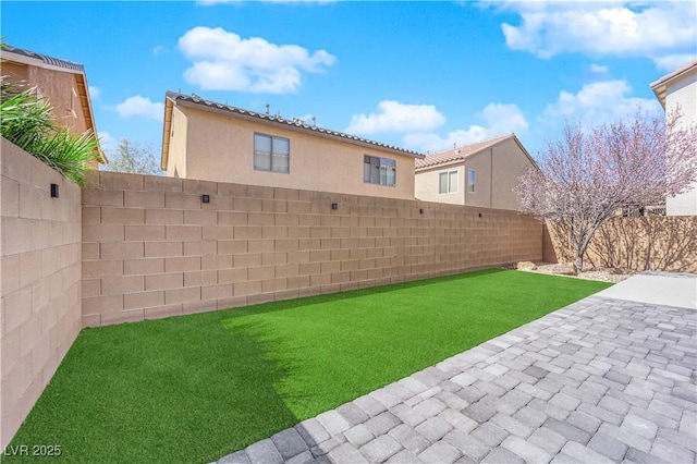 view of yard with a fenced backyard and a patio