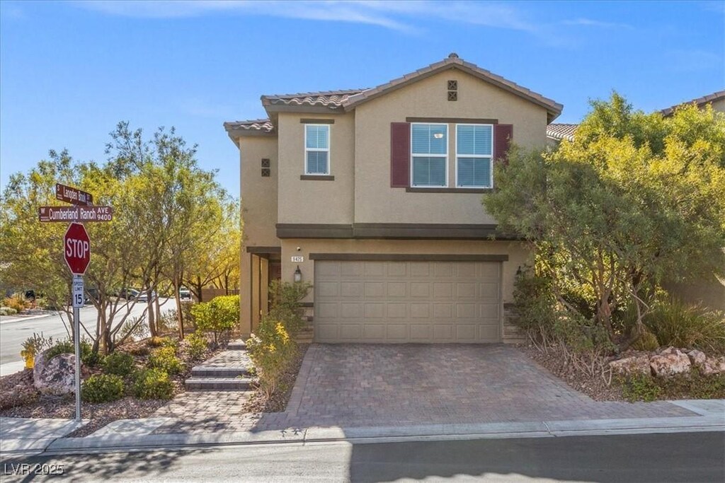 9425 Cumberland Ranch Ave, Las Vegas, NV 89178 - view of front of home featuring a tiled roof, a garage, driveway, and stucco siding