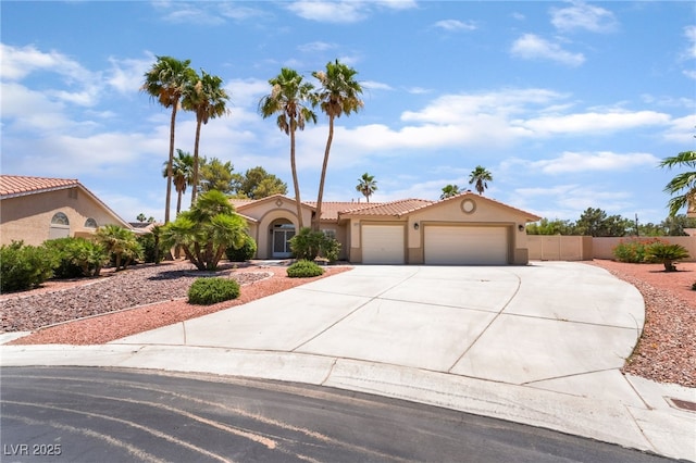5217 Cold River Ave, Las Vegas, NV 89130 - mediterranean / spanish-style home with an attached garage, driveway, stucco siding, and a tile roof