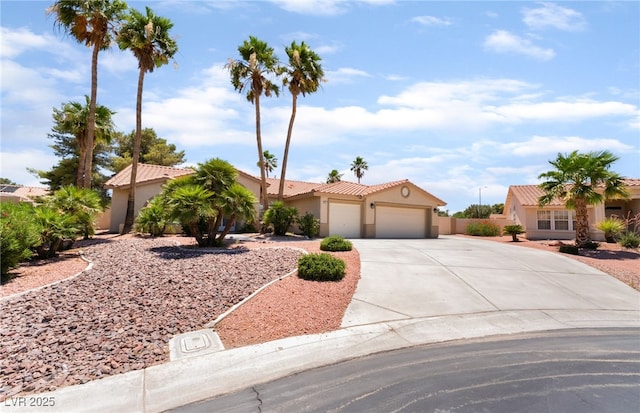 5217 Cold River Ave, Las Vegas, NV 89130 - mediterranean / spanish home with a garage, driveway, stucco siding, and a tiled roof