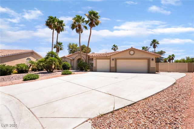 5217 Cold River Ave, Las Vegas, NV 89130 - mediterranean / spanish home with an attached garage, concrete driveway, stucco siding, and a tiled roof
